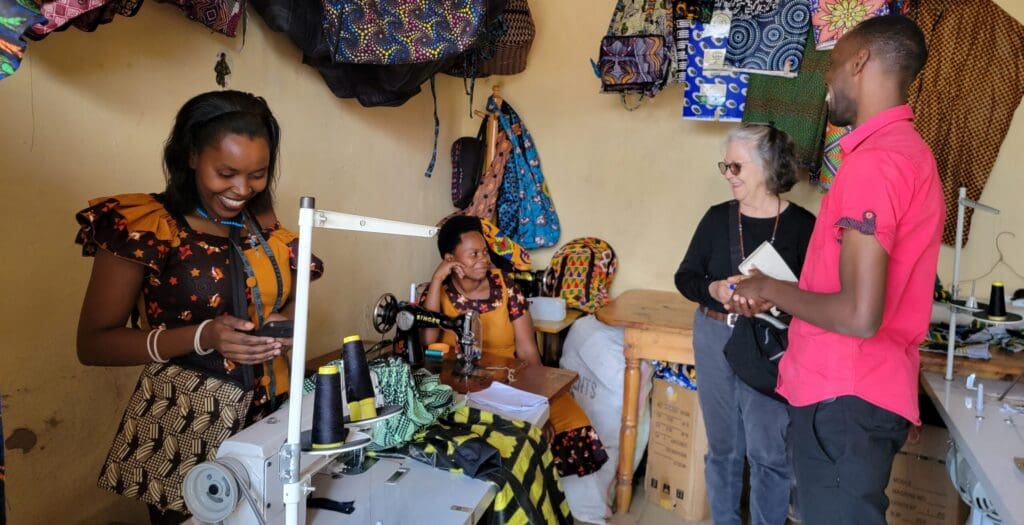 MindLeaps Rwanda also includes a mini-loan component that helps primarily mothers set up businesses together and support one another in changing their financial conditions, such as this co-op that makes everything from briefcases, shopping bags, purses, and clothing in vibrant patterns and colors for sale, as Shaun Pennington, second from right, discovered on a recent visit. (Submitted photo)