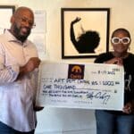 Stefan Carty and Niarus Walker with gift check for CHS