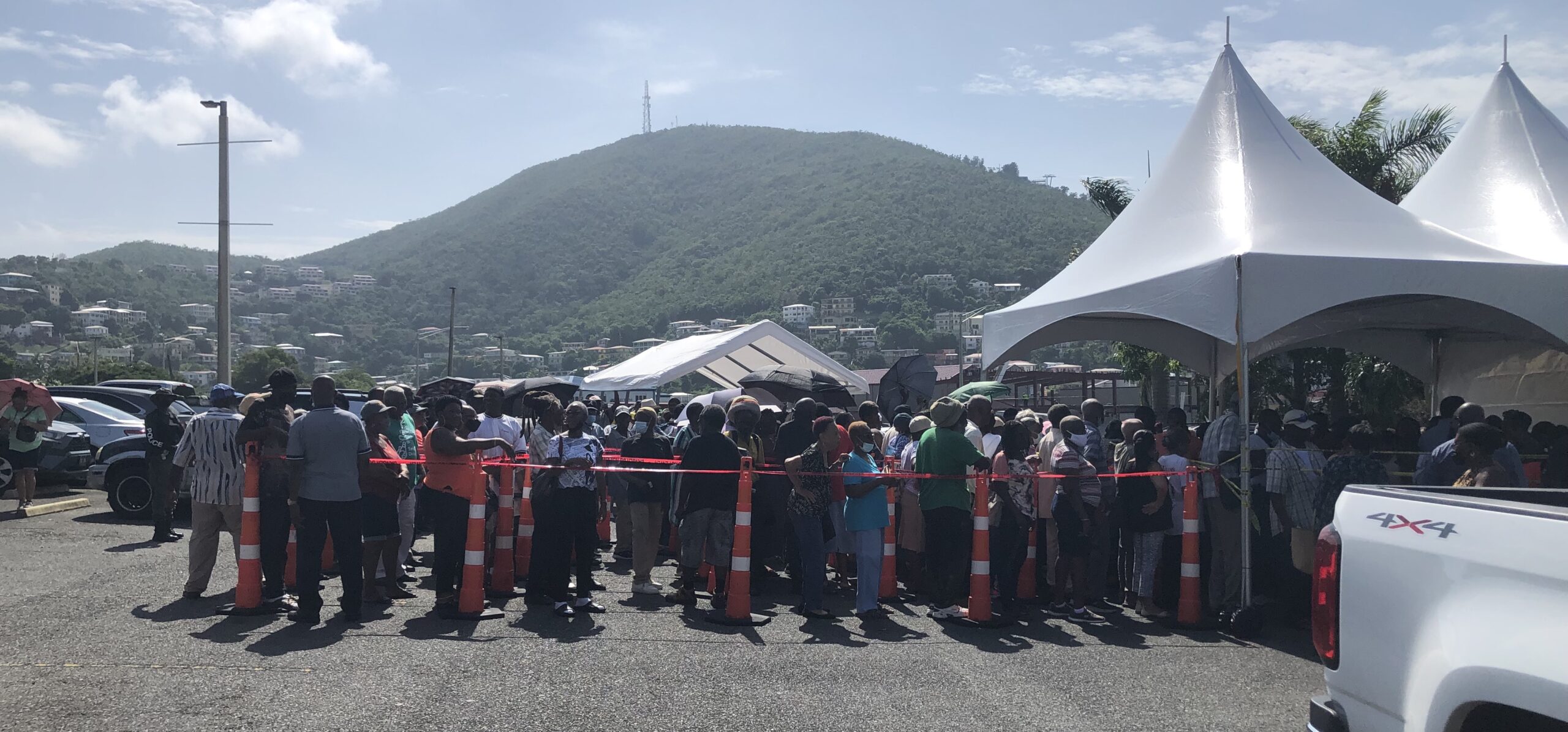 Closer to the tents where checks were being distributed, recipients were corralled into queues much like at the TSA line at airports. (Source photo by Sian Cobb)