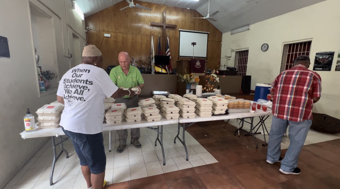 Steve Shegrud, President of the Sunrise Rotary Club on St. Thomas, helps serves meals during The Salvation Army’s Thanksgiving meal distribution (Source photo by Alli Bourne-Vanneck)