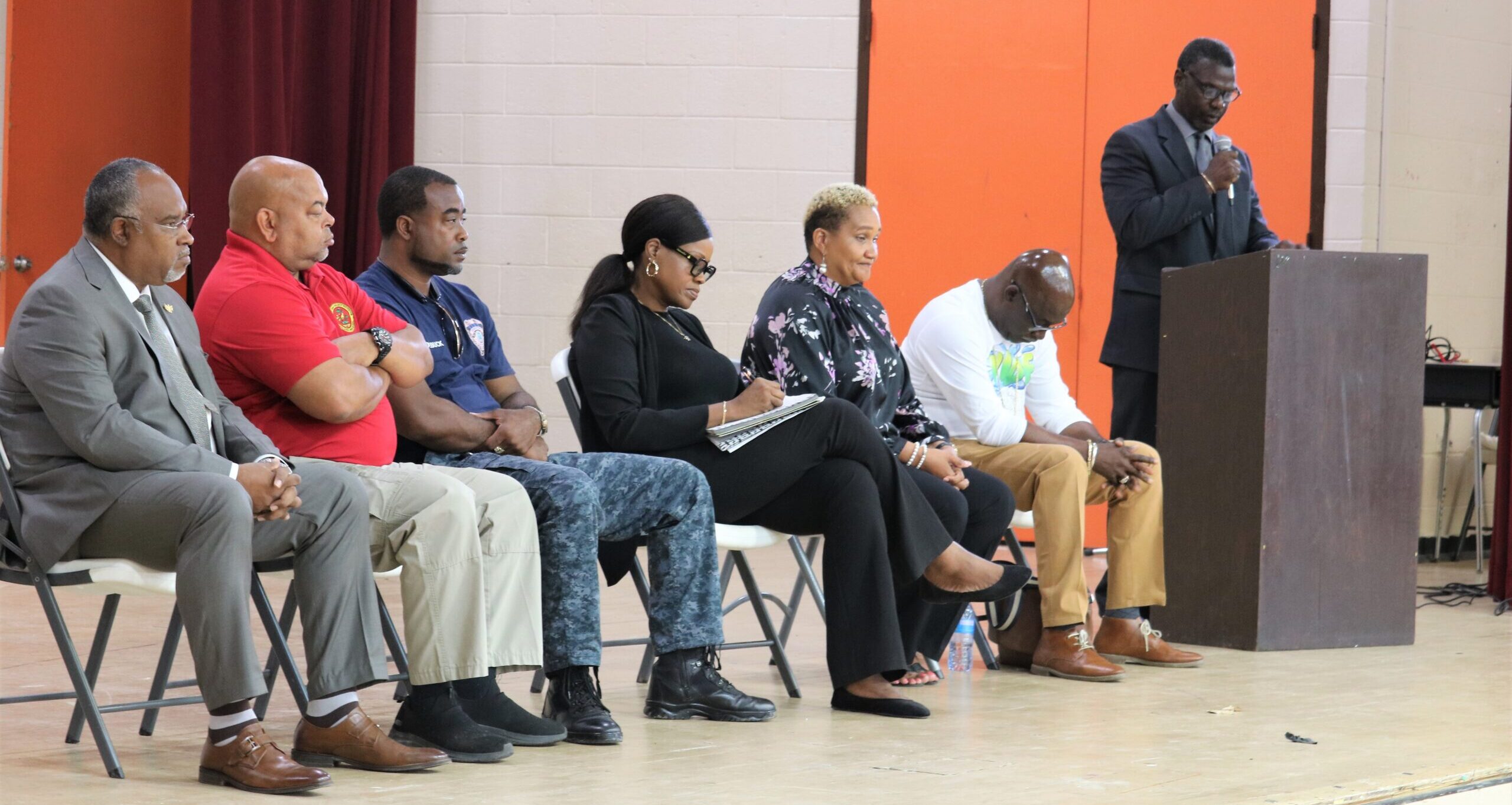 John H. Woodson Jr. High School Principal Henry Mark addresses parents at a meeting held at the school on Friday to provide updates following a BB gun shooting incident on Thursday. From left are Police Commissioner Ray Martinez, Office of Gun Violence Prevention Executive Director Antonio Emanuel, St. Croix District School Safety Manager Jaime Roebuck Sr., St. Croix District Deputy Superintendent Karen Chancellor, Education Commissioner Dionne Wells-Hedrington, and VIDE Director or Disaster Planning and School Security Irvin Mason. (Photo courtesy V.I. Education Department)