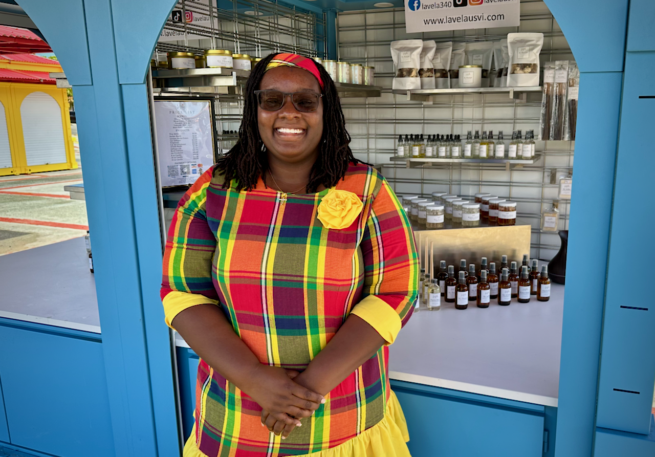 New vendor at Vendors Plaza Amandla Williams welcomes visitors to her new space, where she offers made in the Virgin Islands air fragrances, candles, aroma beads and diffuser oils. (Photo by Roger Stevens)