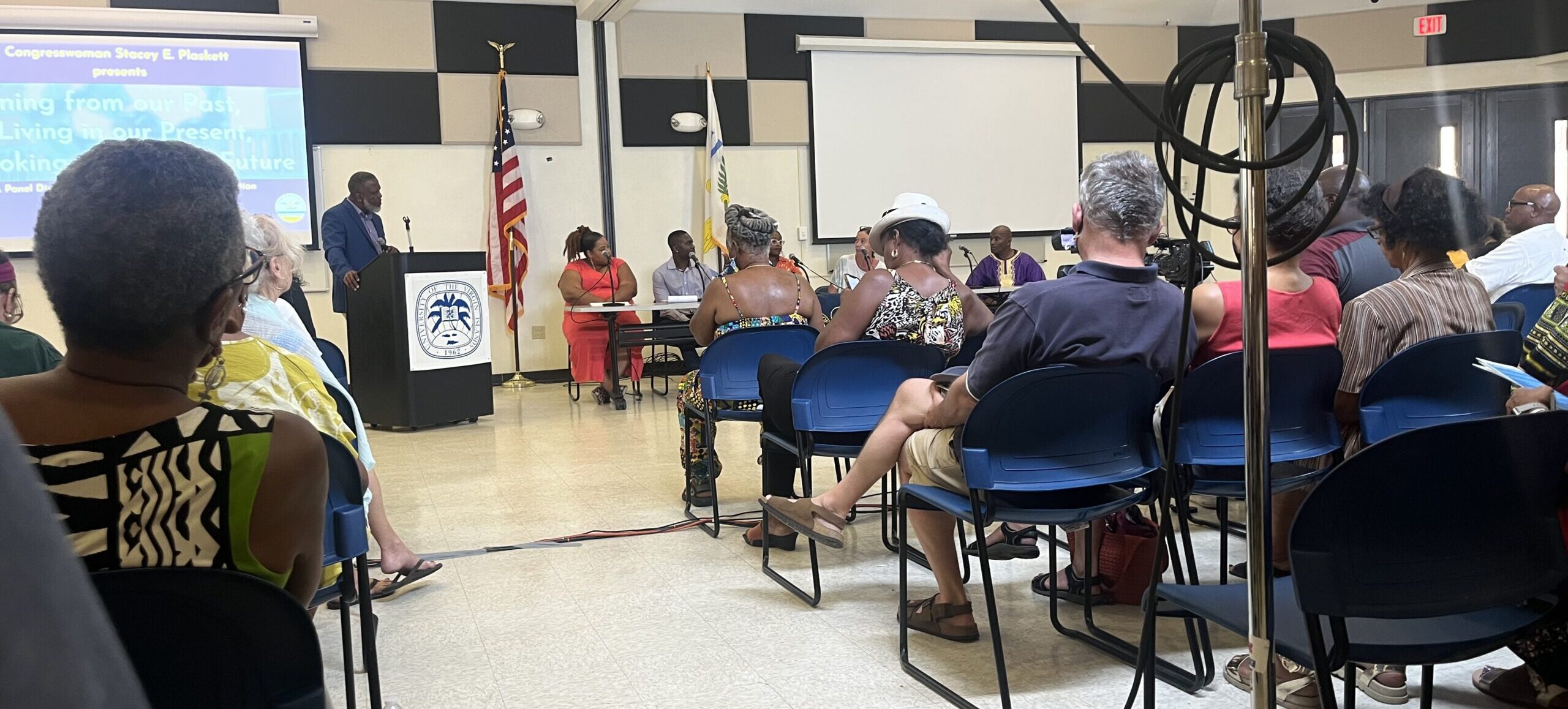 Panel and audience at a discussion in honor of the 175th Emancipation Day Commemoration. (V.I. Source photo by Diana Dias) 
