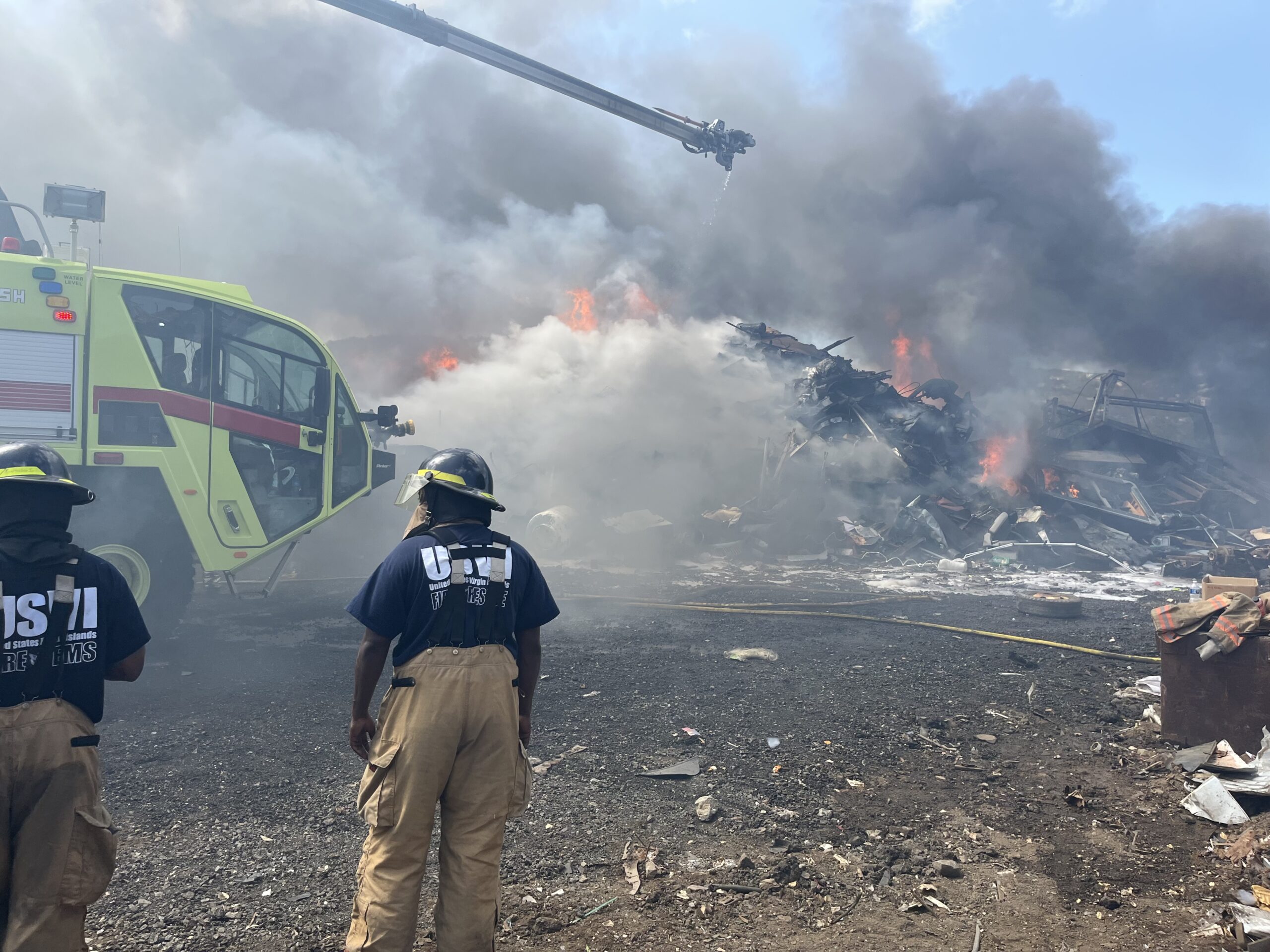 Firefighters work to extinguish a blaze that broke out Friday at the entrance to the Bovoni Landfill on St. Thomas. (Photo courtesy VIFEMS)