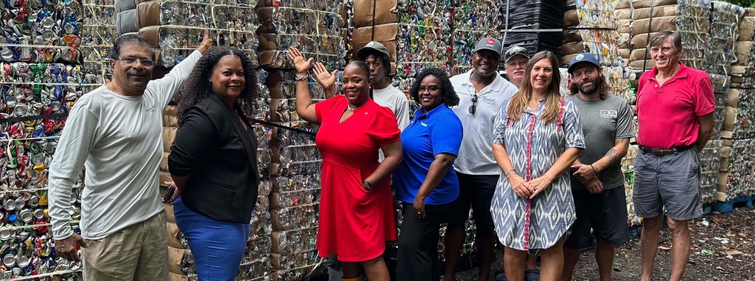 Surveying bales of recycled cans are Island Green Living President Harith Wickrema; Acting District Director LuAnne Hodge, Delegate Stacey Plaskett’s office; St. John Administrator Shikima Jones-Sprauve; recycling team member Akeino Williams; Nakira Yanick Nesbitt-Daniel, Tropical Shipping; Island Green Board Treasurer Curtis Penn; staff member John Baker; Executive Director Kelly McKinney; staff member Jesse Crosby; and Board Member Rob Crane. (Photo courtesy Island Green Living)