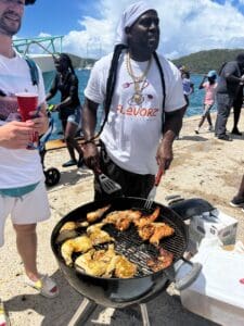 B Flavorz cooks up chicken and lobster tails on the grill. (Source photo by Lara Halliday)