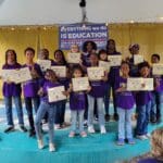 Youths and teens holding certificates and trophies at end of performance. They all wrote cards for Selentia Moore.