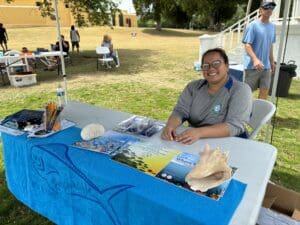 Eva Collazo, with DPNR’s Fish and Wildlife, handed out literature about fishing sustainably, Reef Responsible and gifts, Saturday. (Source photo by Susan Ellis)