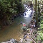 Hikers in waterfall