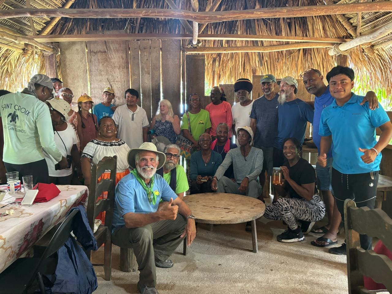 The hikers at their guide Ben's home, where they enjoyed a meal and took a picture together. As they held hands and bowed their heads for prayer, Cathy Prince, the president of the hiking association, thanked the family for hosting them and blessed the food in English. Ben blessed the food and fellowship in the Mayan language. (Photo by Noel Tzub)