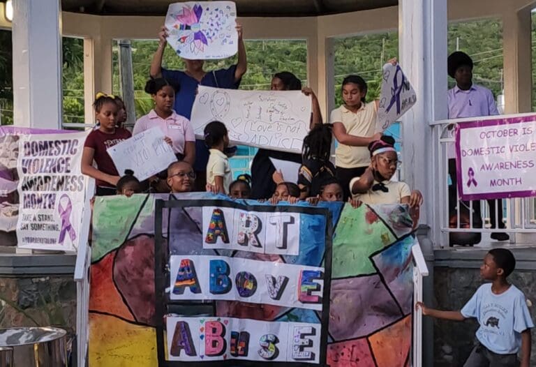 Students at the St. John School of the Arts display artwork at last year’s March Against Domestic Violence. (Photo by the St. John School of the Arts)
