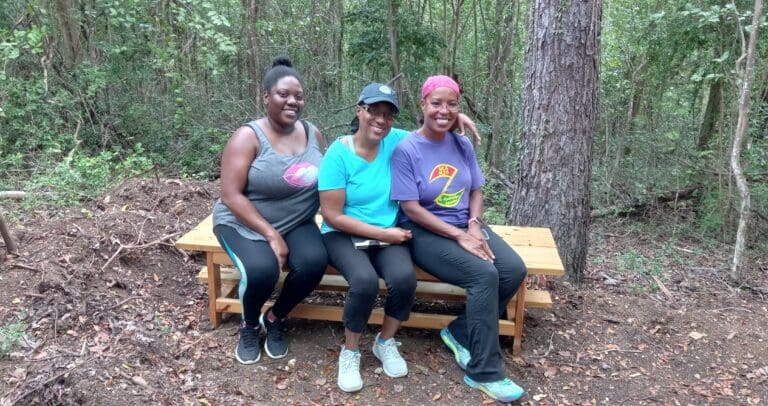 Shana, Jackies, and Lisa rest their feet at the Estate Windsor Forest Nature Trail on St. Croix. (Photo by Olasee Davis)