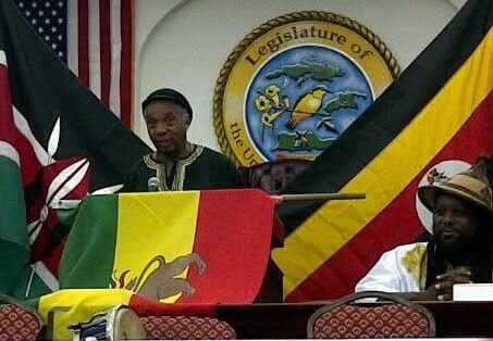 Gene Emanuel and Jermaine “Ras Koniyah” Pemberton speak at a cultural event in the Earle B. Ottley legislative chamber, two honourees who will be recognized during the Rastafari Day ceremonies for their contributions to local cultural advocacy and preservation. (Conch Shell Media, LLC photo)