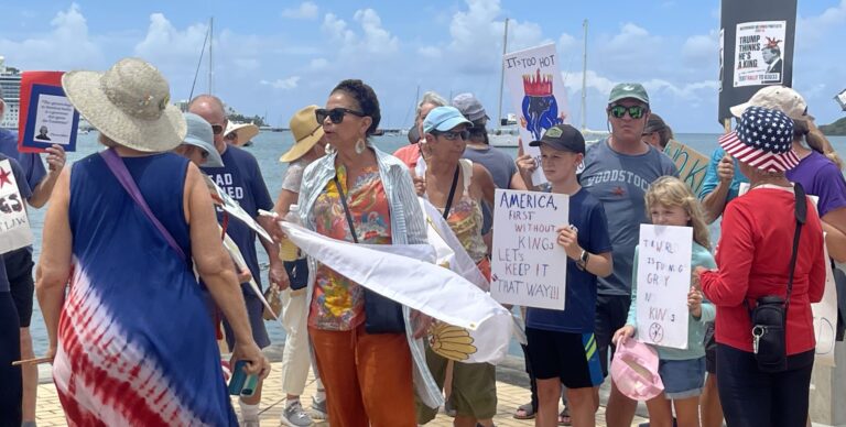 Marchers walk down along the St. Thomas waterfront during the “No Kings” rally in June. (Photo by Barbara Young)