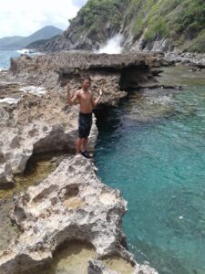 A Crucian youth enjoys the tidepool at the newly establish Maroon Sanctuary Territorial Park, the largest in the Virgin Islands, with its jagged coastline on northwest St. Croix. (Photo by Olasee Davis)