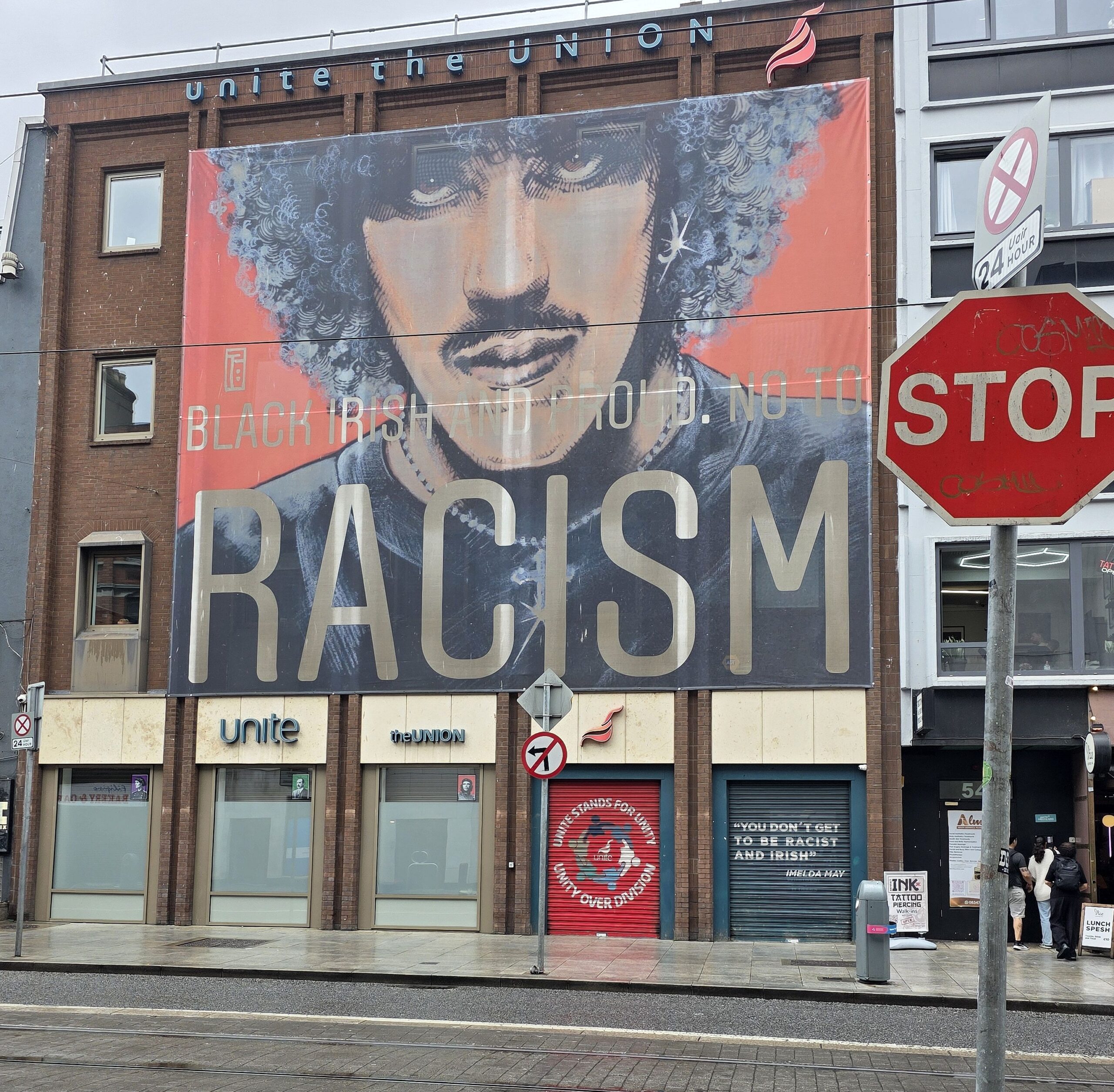 A stop sign in Dublin, Ireland, offers a moment to take in a mural decrying racism. (Source photo by Shaun A. Pennington)