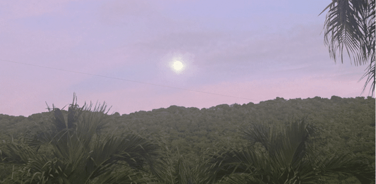 A nearly full moon is poised above the hills of Maroon Country in the cool of dawn as the morning sky inhales early light, gradually becoming flushed with lavender hues. (Photo by Joshua Grant Canning)