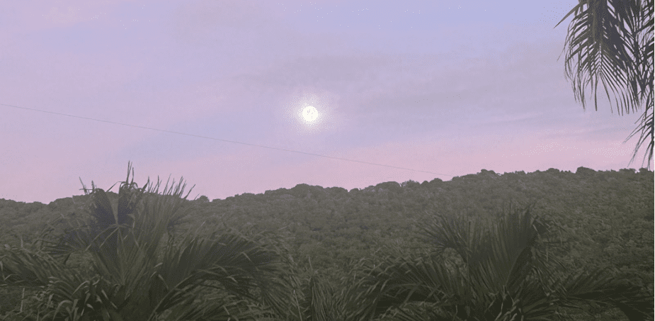 A nearly full moon is poised above the hills of Maroon Country in the cool of dawn as the morning sky inhales early light, gradually becoming flushed with lavender hues. (Photo by Joshua Grant Canning)