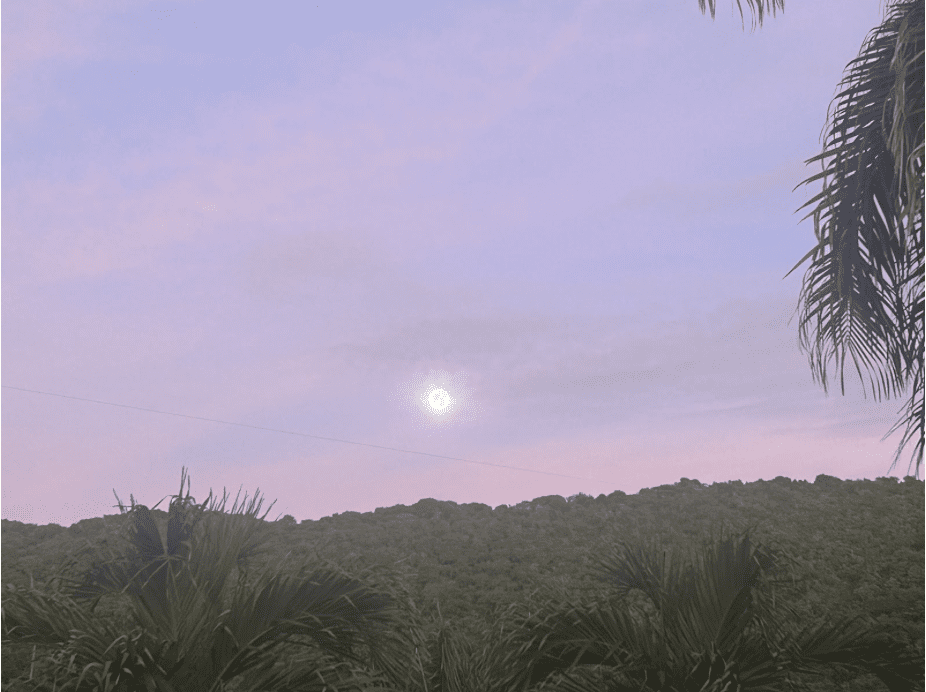 A nearly full moon is poised above the hills of Maroon Country in the cool of dawn as the morning sky inhales early light, gradually becoming flushed with lavender hues. (Photo by Joshua Grant Canning)