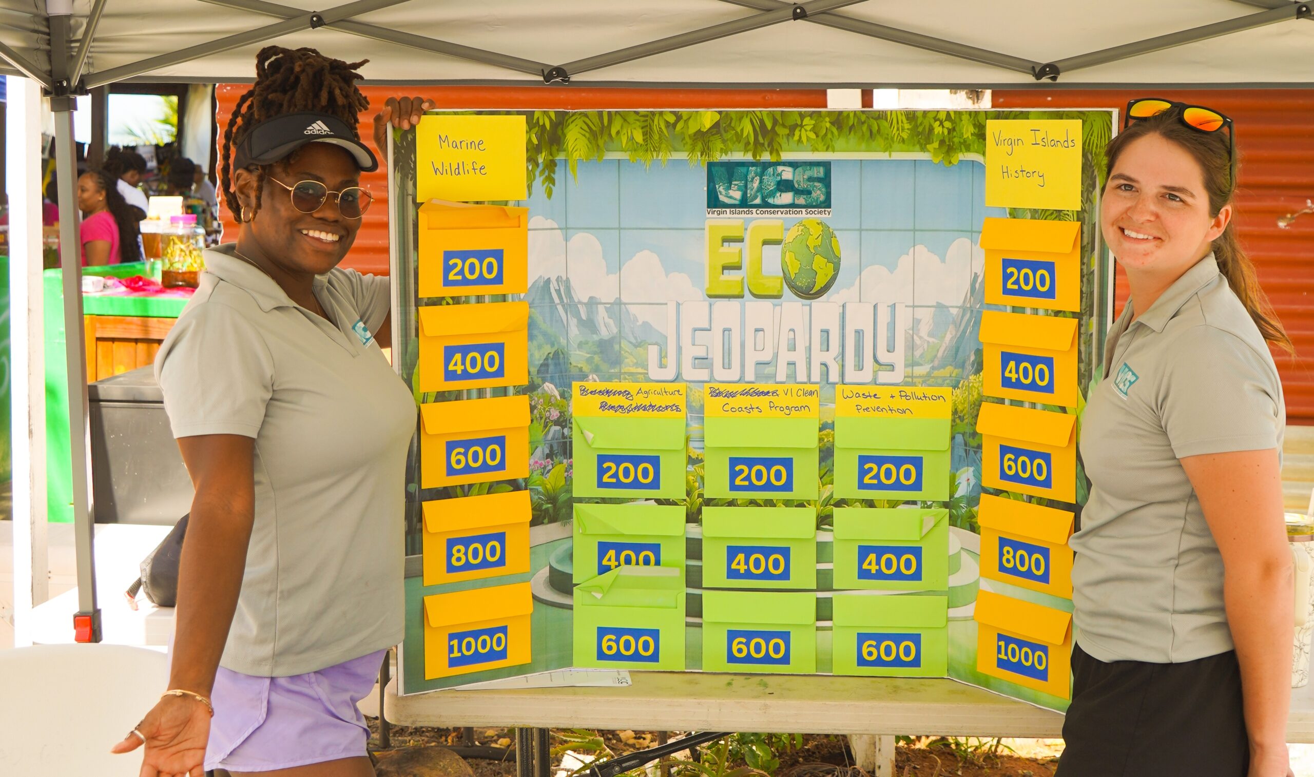 Zenobia Howe and Sienna Gray stand behind VICC informational table at a recent outreach event. (Photo courtesy Zoe Banfield)