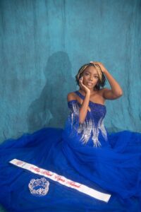 Majestik Freedom poses for picture wearing a sequined blue dress, sash, and crown. (Photo courtesy Winx Flix Photography)