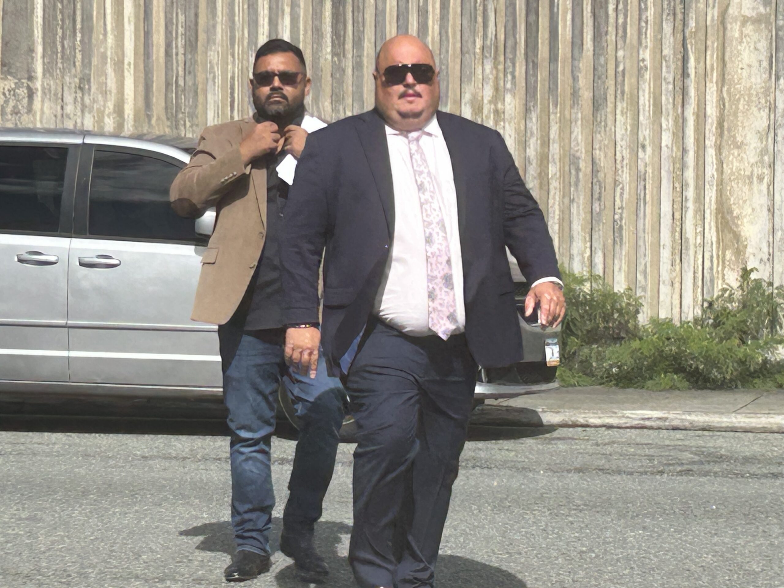 Mac McClafferty, front, and his business partner Sunil Sharma arrive at the Magistrate Division of Superior Court Friday on St. Thomas. (Source photo by Siân Cobb)