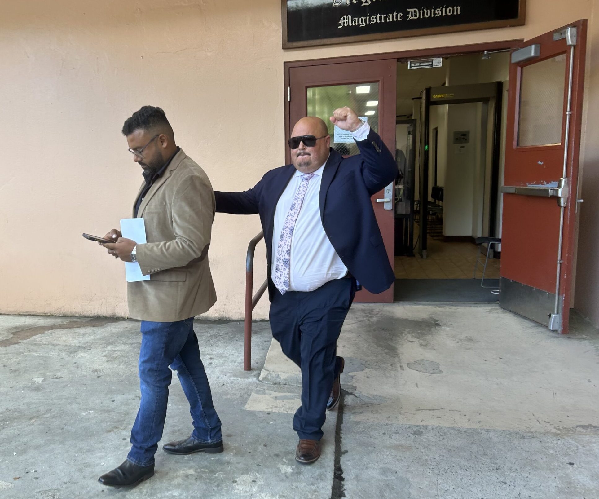 Brett "Mac" McClafferty raises his fist in the air as he leaves Magistrate Court Friday on St. Thomas. (Source photo by Siân Cobb)