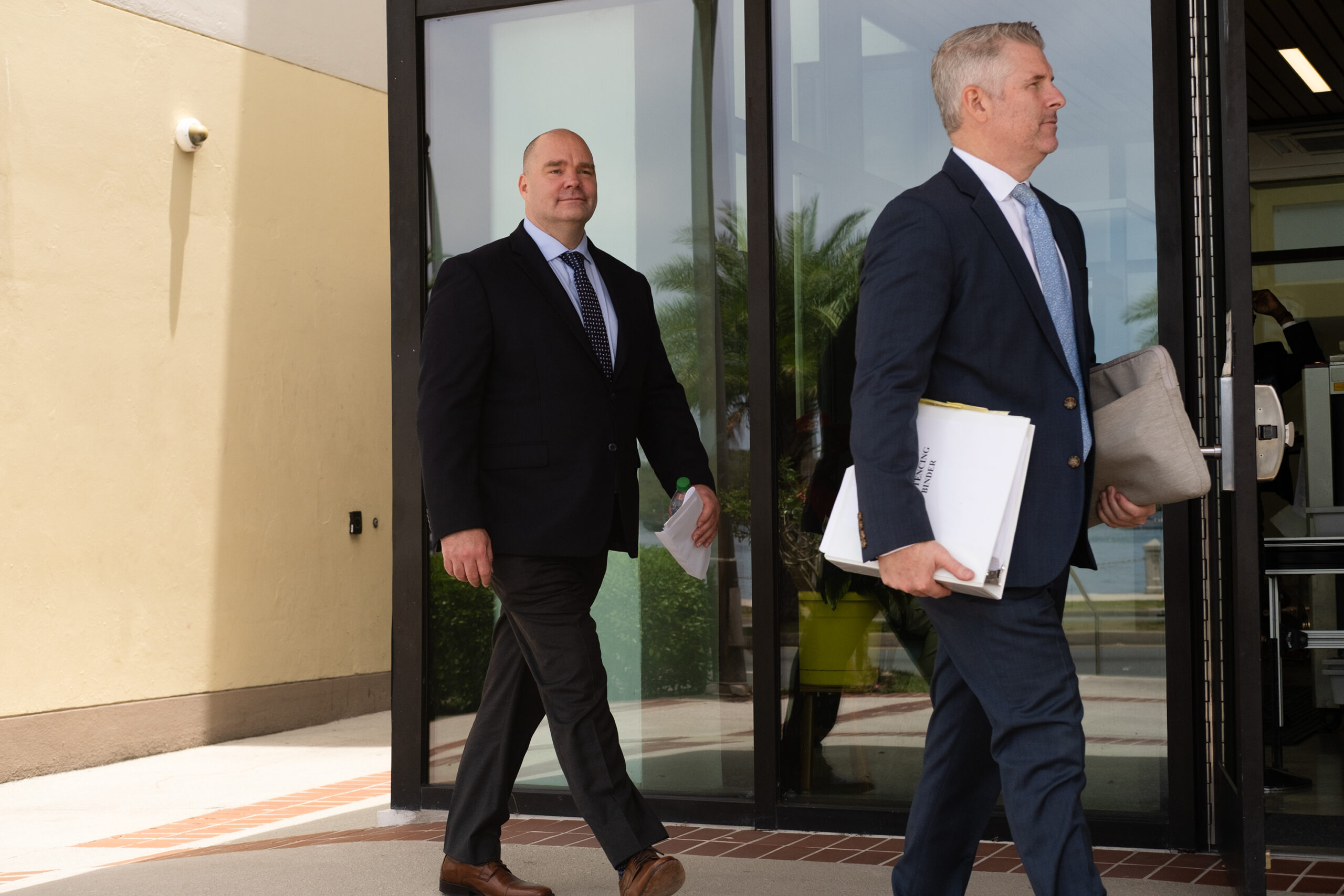 Cutline: David Whitaker, left, leaves the federal courthouse with attorney David Cattie, right, after a sentencing hearing Wednesday on St. Thomas. (Source photo by Kit MacAvoy)